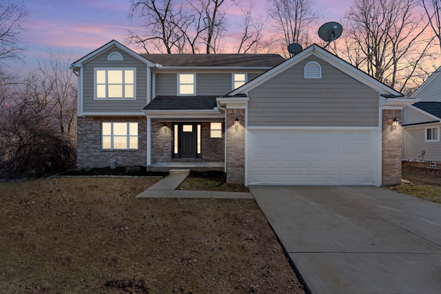 traditional home featuring an attached garage, brick siding, concrete driveway, and roof with shingles