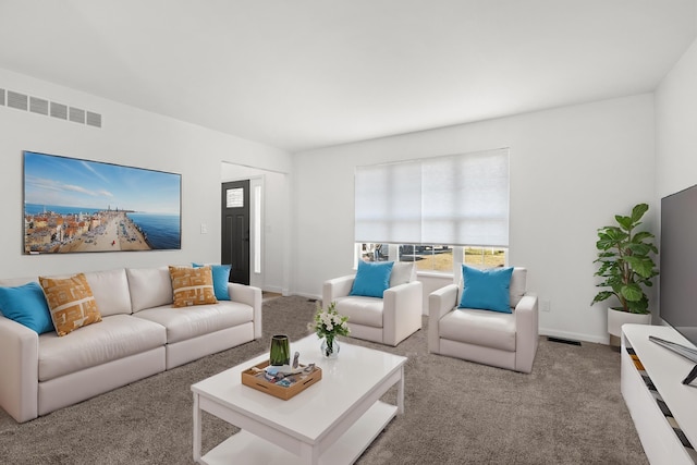carpeted living area with baseboards and visible vents