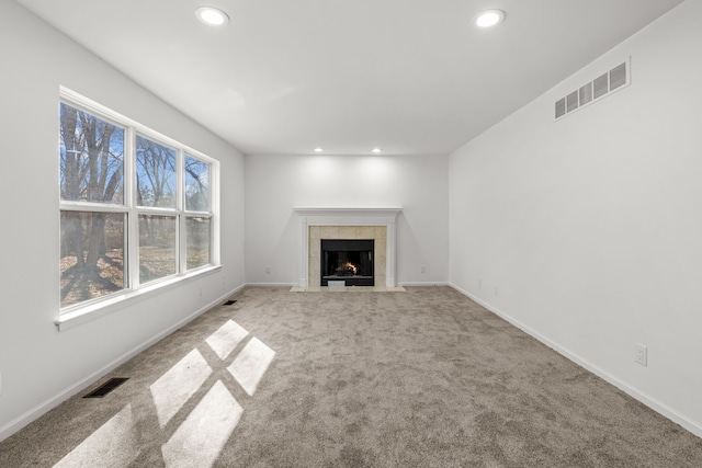 unfurnished living room with carpet flooring, a fireplace, visible vents, and recessed lighting