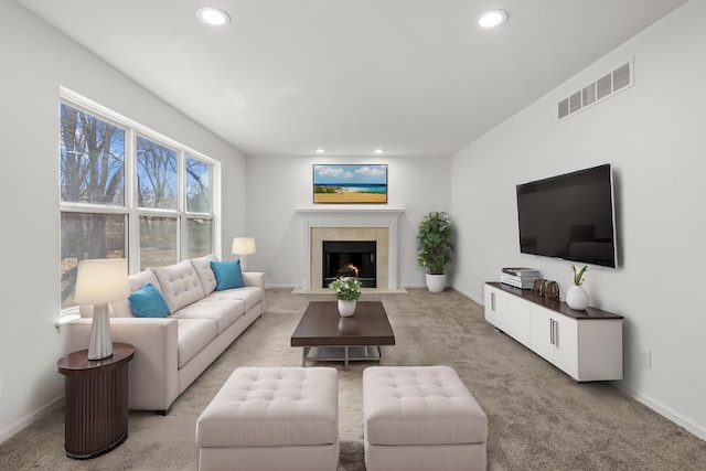 living area featuring recessed lighting, baseboards, light colored carpet, and visible vents