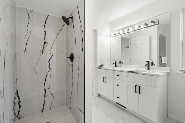 full bathroom with marble finish floor, double vanity, a sink, and a marble finish shower