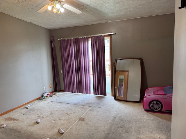 25966 Peppertree Ln, Warren, MI 48091 - empty room featuring carpet, a textured ceiling, baseboards, and ceiling fan