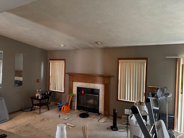 25966 Peppertree Ln, Warren, MI 48091 - living room featuring baseboards, a tiled fireplace, and a textured ceiling