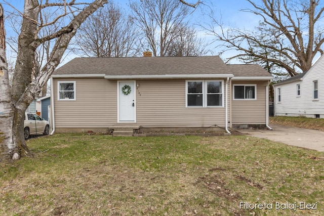 2100 Dawson Ave NE, Grand Rapids, MI 49505 - view of front of property with a front yard, entry steps, roof with shingles, and a chimney