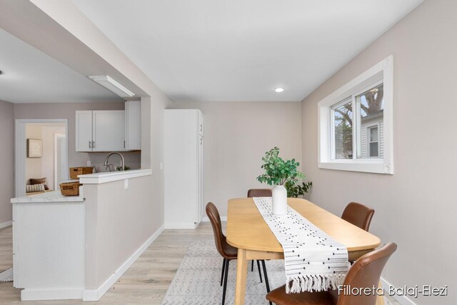 2100 Dawson Ave NE, Grand Rapids, MI 49505 - dining area with baseboards and light wood-type flooring