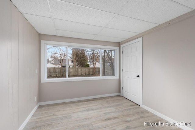 2100 Dawson Ave NE, Grand Rapids, MI 49505 - unfurnished room featuring baseboards, wood finished floors, and a paneled ceiling
