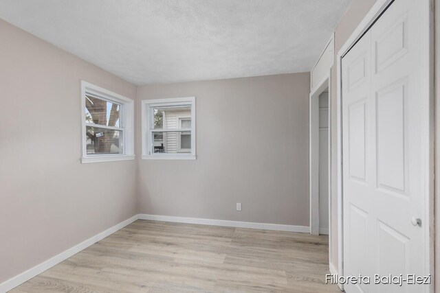 2100 Dawson Ave NE, Grand Rapids, MI 49505 - unfurnished bedroom featuring a closet, baseboards, and light wood-type flooring