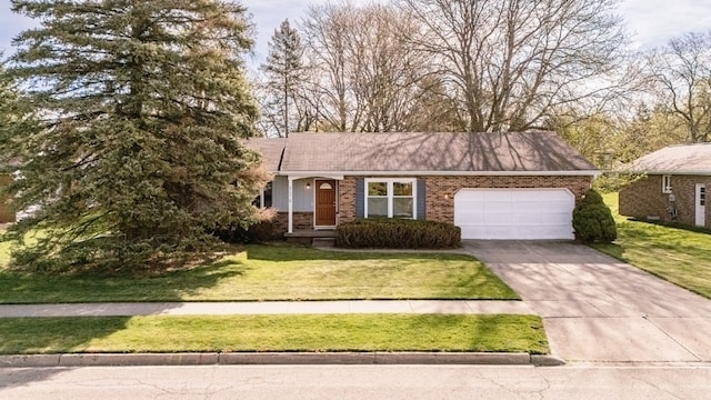 single story home with concrete driveway, a front yard, brick siding, and a garage