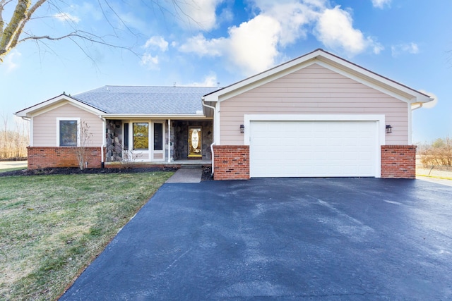 1405 S Sashabaw Rd, Ortonville, MI 48462 - ranch-style home featuring stone siding, a garage, a front yard, brick siding, and driveway