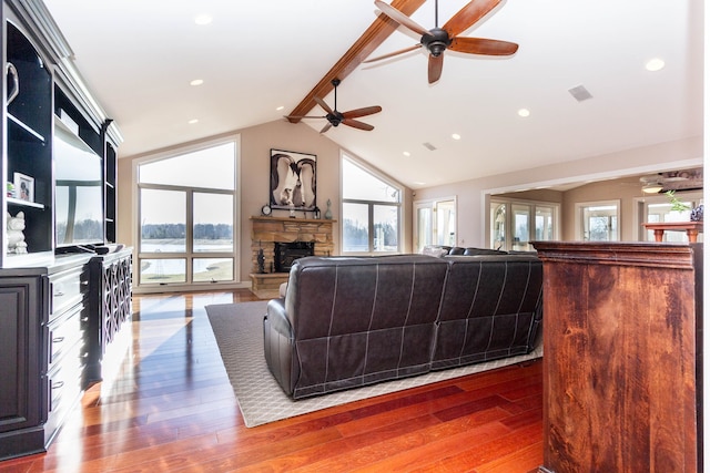 1405 S Sashabaw Rd, Ortonville, MI 48462 - living area featuring hardwood / wood-style flooring, a fireplace, lofted ceiling with beams, visible vents, and ceiling fan