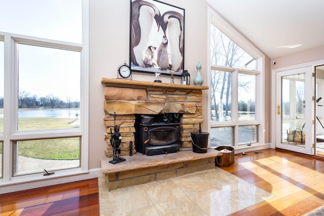 1405 S Sashabaw Rd, Ortonville, MI 48462 - living room with a water view, visible vents, wood finished floors, and a wood stove