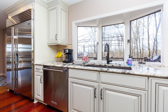 1405 S Sashabaw Rd, Ortonville, MI 48462 - kitchen featuring white cabinetry, dark wood-style flooring, backsplash, a sink, and appliances with stainless steel finishes
