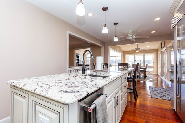 1405 S Sashabaw Rd, Ortonville, MI 48462 - kitchen featuring white cabinets, a ceiling fan, dark wood finished floors, a sink, and decorative light fixtures