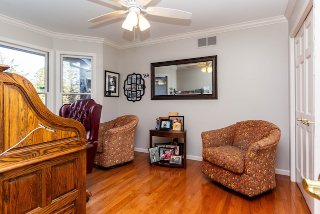 1405 S Sashabaw Rd, Ortonville, MI 48462 - sitting room with wood finished floors, crown molding, ceiling fan, and visible vents