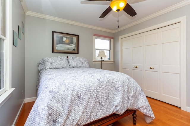 1405 S Sashabaw Rd, Ortonville, MI 48462 - bedroom featuring a closet, a ceiling fan, light wood finished floors, baseboards, and ornamental molding