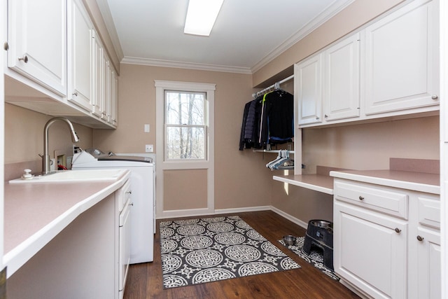 1405 S Sashabaw Rd, Ortonville, MI 48462 - washroom with washer and clothes dryer, crown molding, dark wood-style floors, baseboards, and cabinet space