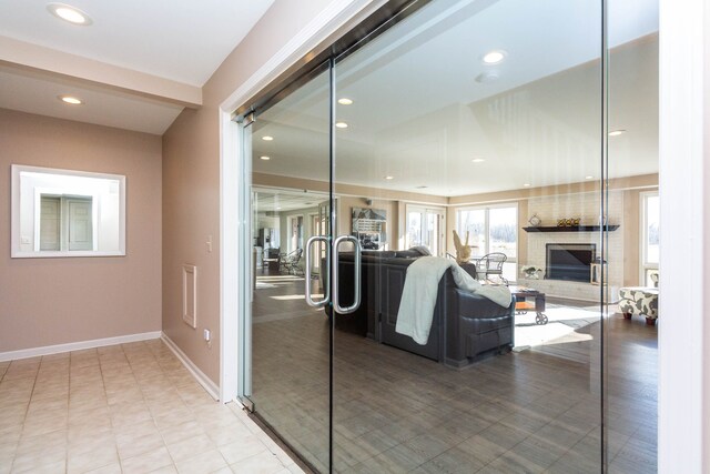 1405 S Sashabaw Rd, Ortonville, MI 48462 - living room with baseboards, a fireplace, tile patterned flooring, and recessed lighting