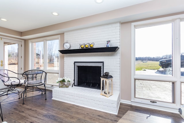 1405 S Sashabaw Rd, Ortonville, MI 48462 - living room with wood finished floors, recessed lighting, and a brick fireplace