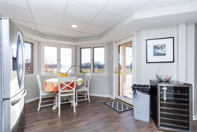 1405 S Sashabaw Rd, Ortonville, MI 48462 - dining area with baseboards, wood finished floors, wine cooler, and a drop ceiling