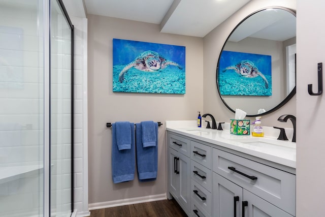 1405 S Sashabaw Rd, Ortonville, MI 48462 - bathroom with double vanity, a sink, a shower stall, and wood finished floors