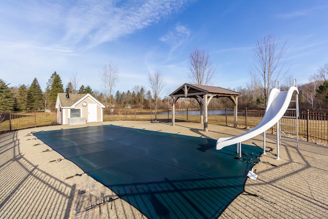 1405 S Sashabaw Rd, Ortonville, MI 48462 - view of swimming pool featuring a fenced in pool, a gazebo, a water slide, an outbuilding, and fence