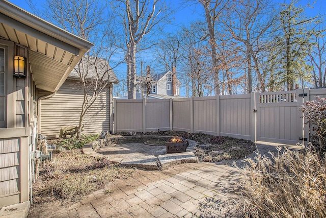 view of patio / terrace featuring a fire pit, a gate, and fence