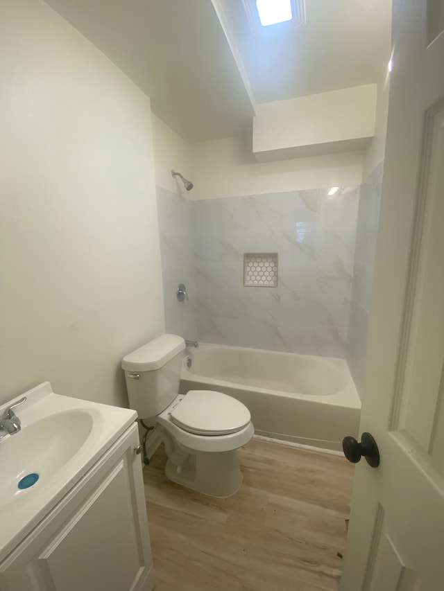 20746 Westland Dr, Southfield, MI 48075 - full bath featuring toilet, vanity, washtub / shower combination, and wood finished floors