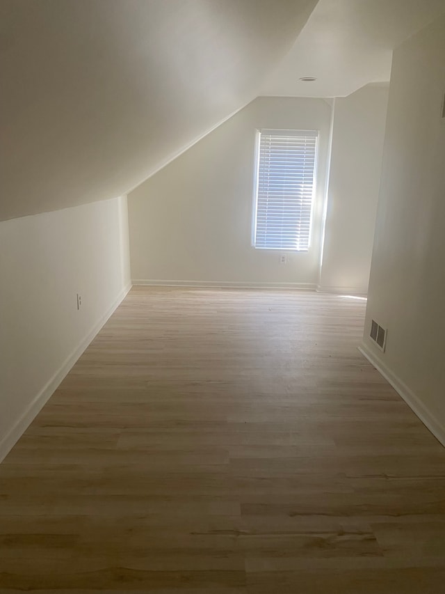 20746 Westland Dr, Southfield, MI 48075 - bonus room with vaulted ceiling, baseboards, light wood finished floors, and visible vents