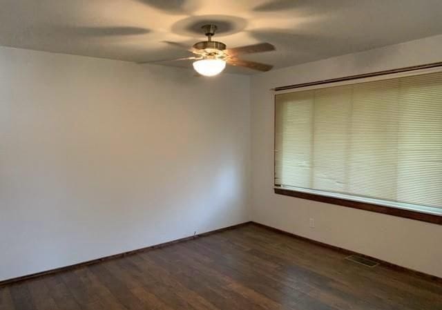 43300 N Interstate 94 Service Dr, Belleville, MI 48111 - empty room with a ceiling fan, dark wood-style floors, baseboards, and visible vents