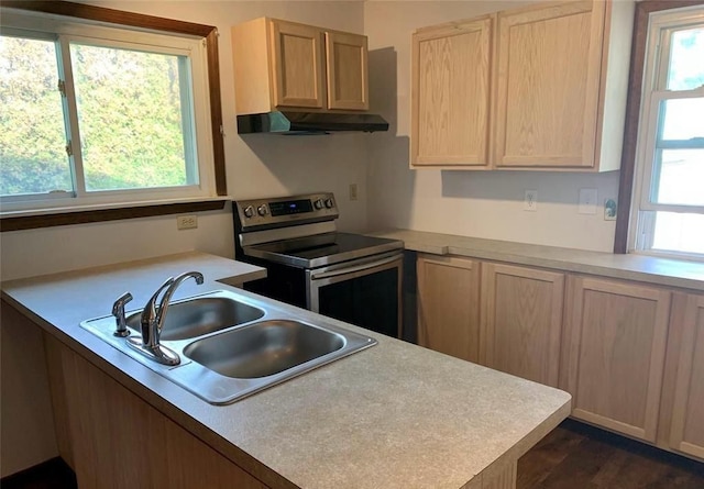 43300 N Interstate 94 Service Dr, Belleville, MI 48111 - kitchen with light countertops, under cabinet range hood, electric stove, a sink, and light brown cabinets