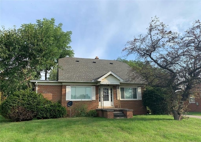 43300 N Interstate 94 Service Dr, Belleville, MI 48111 - bungalow-style house featuring brick siding, a shingled roof, and a front lawn