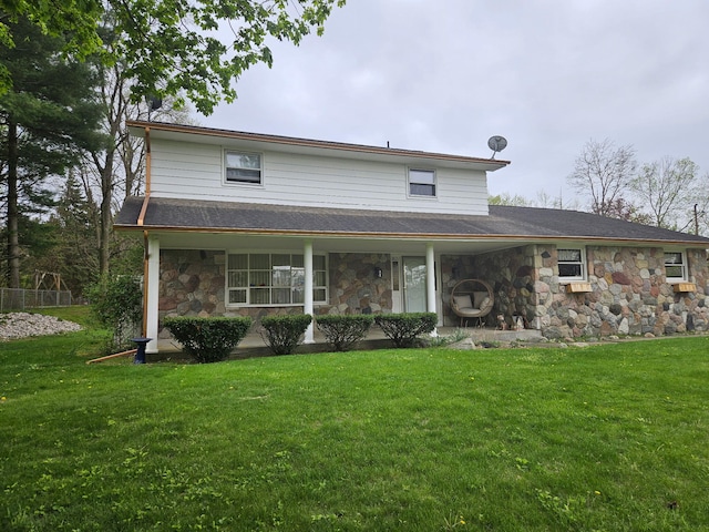 3621 Northview Dr, Kalamazoo, MI 49004 - farmhouse featuring stone siding, covered porch, and a front yard