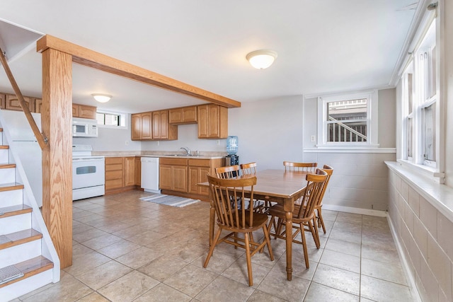 dining room featuring light tile patterned flooring and stairs