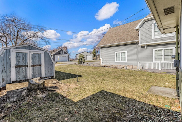 view of yard featuring a storage shed and an outdoor structure