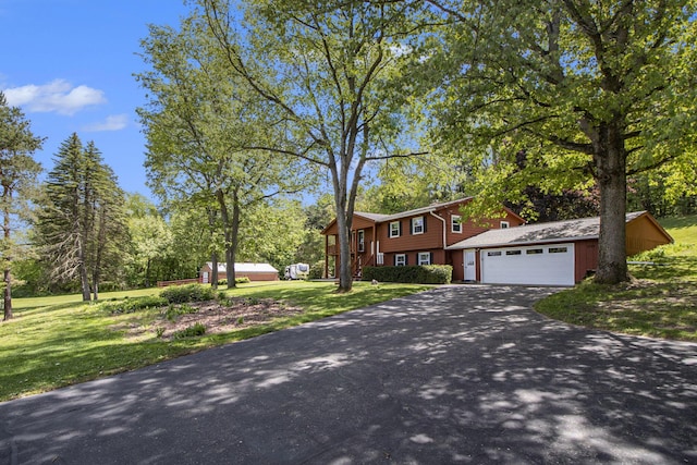 2725 W B Ave, Plainwell, MI 49080 - view of front of home featuring asphalt driveway, a front lawn, and an attached garage
