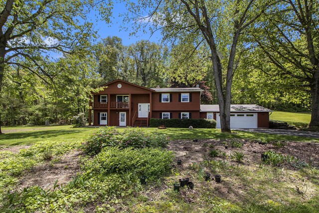 2725 W B Ave, Plainwell, MI 49080 - view of front of home featuring a garage, a front yard, driveway, and a chimney