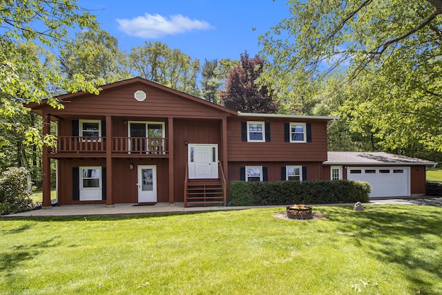 2725 W B Ave, Plainwell, MI 49080 - raised ranch with an attached garage, a front yard, a fire pit, concrete driveway, and a balcony