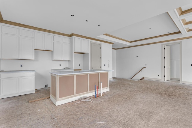 215 Nottingham Dr, Brooklyn, MI 49230 - kitchen with crown molding, white cabinets, a kitchen island, a tray ceiling, and baseboards