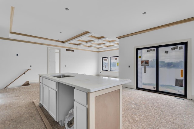215 Nottingham Dr, Brooklyn, MI 49230 - kitchen with crown molding, coffered ceiling, a kitchen island with sink, white cabinets, and beamed ceiling