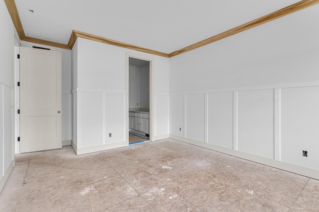 215 Nottingham Dr, Brooklyn, MI 49230 - unfurnished bedroom featuring a decorative wall, crown molding, wainscoting, and ensuite bathroom