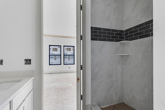 215 Nottingham Dr, Brooklyn, MI 49230 - bathroom featuring a tile shower and vanity
