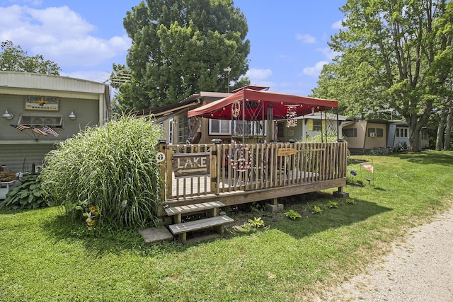 wooden deck featuring a yard