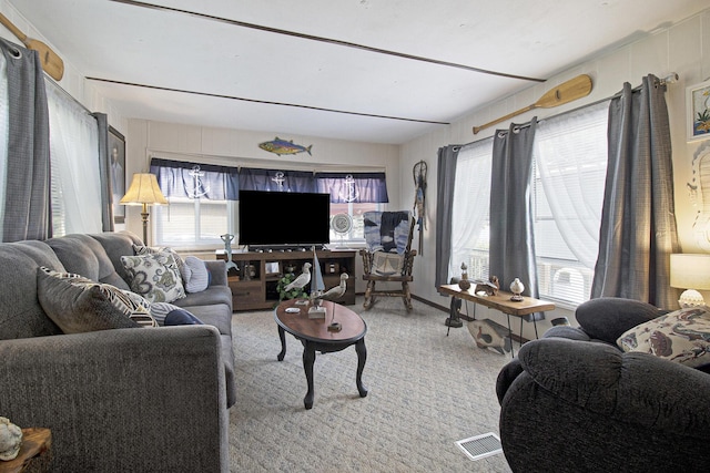 living room with visible vents and light colored carpet