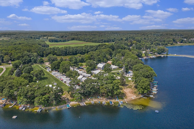 aerial view with a water view and a wooded view