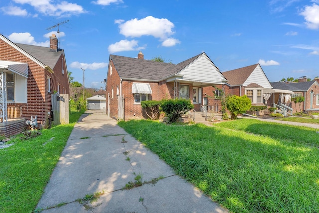 17189 Albion Ave, Detroit, MI 48234 - bungalow-style home featuring an outdoor structure, a front lawn, brick siding, a garage, and a chimney