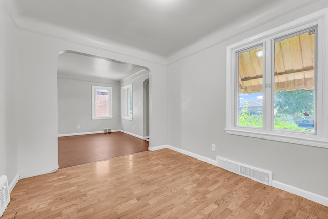 17189 Albion Ave, Detroit, MI 48234 - empty room featuring wood finished floors, arched walkways, and visible vents