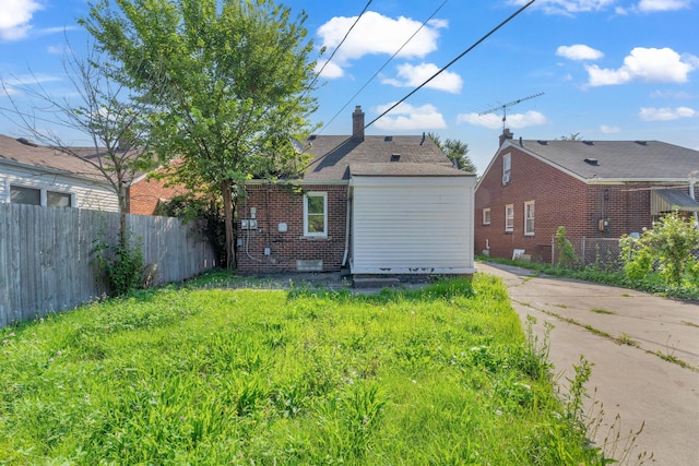 17189 Albion Ave, Detroit, MI 48234 - rear view of house featuring brick siding, fence, and a chimney