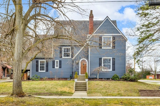 1515 W Franklin St, Jackson, MI 49203 - view of front of home with a chimney and a front lawn