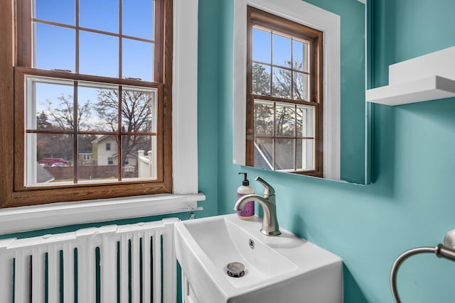 1515 W Franklin St, Jackson, MI 49203 - bathroom featuring a sink and radiator