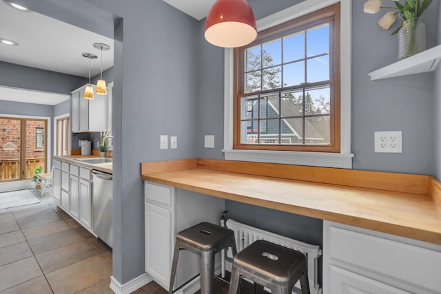 1515 W Franklin St, Jackson, MI 49203 - kitchen with dishwasher, wooden counters, a sink, and white cabinets